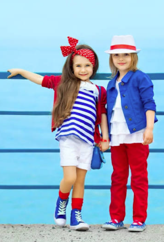 Two children in coordinated red, white, and blue outfits