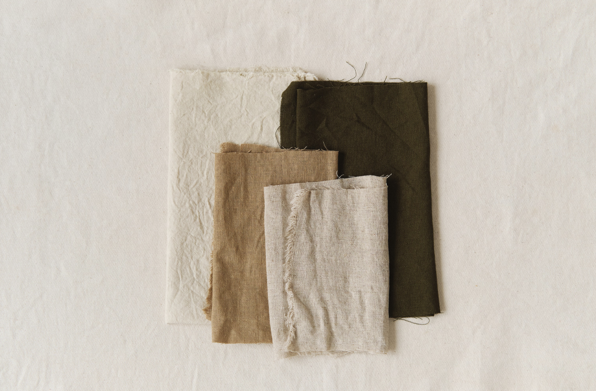 Folded kitchen linen fabric swatches in natural tones